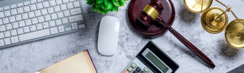 a lawyer's desk featuring keyboard and gavel