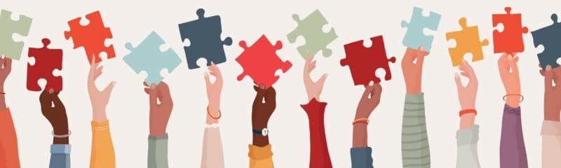 a series of hands holding puzzle pieces to showcase employer branding